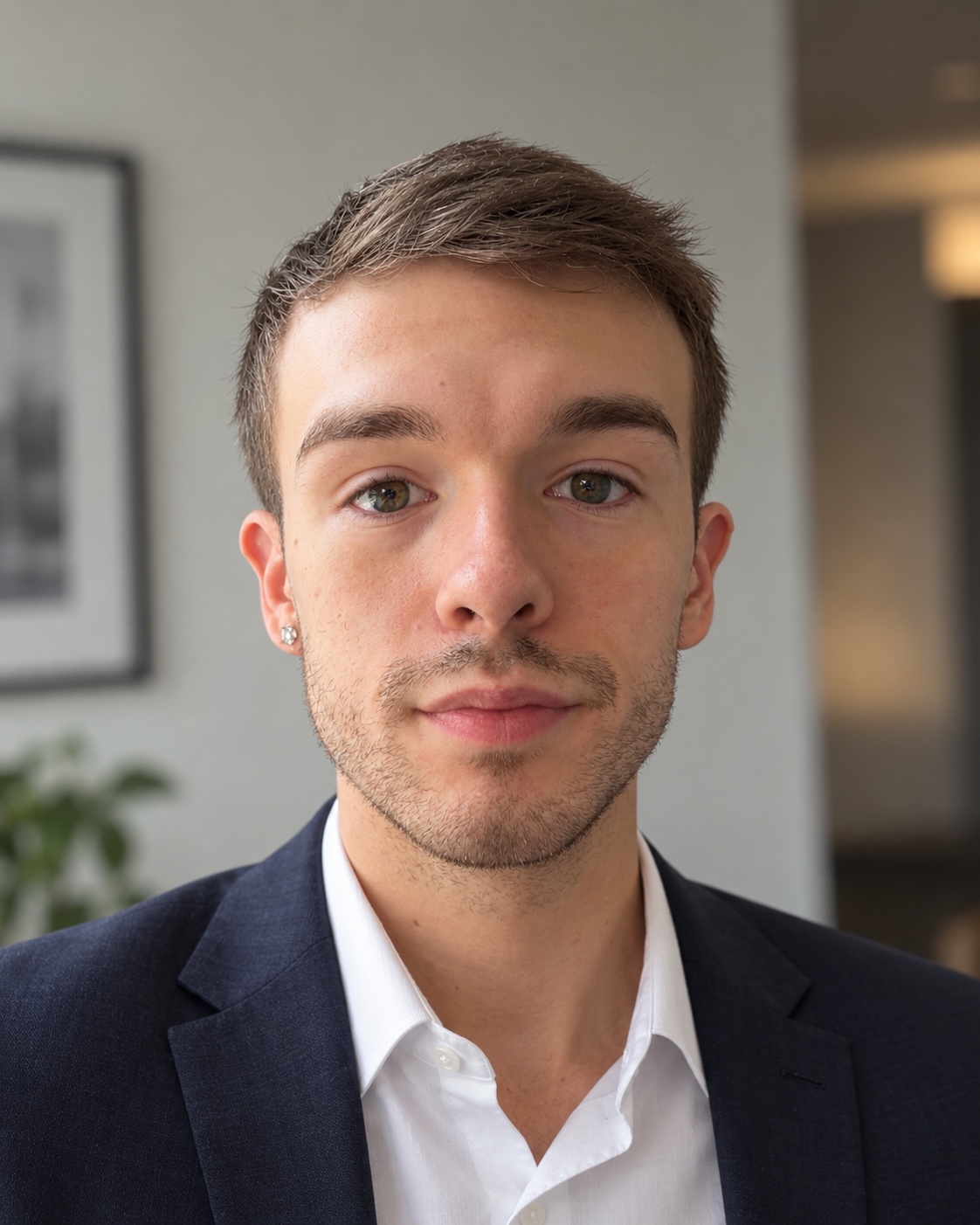 Professional headshot of Erich Lipner wearing a navy blazer and white shirt
